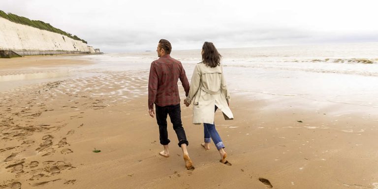 walking couple on beach